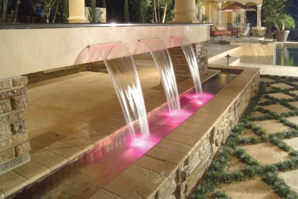 Illuminated water fountain in a Dubai garden at night